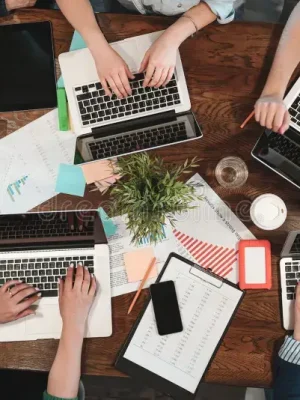 top-view-young-coworking-people-working-laptops-paper-documents-group-college-students-using-laptop-sittin-114976555 top-view-young-coworking-people-working-laptops-paper-documents-group-college-students-using-laptop-sittin-114976555